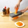 Carrot being grated with the vegetable chopper.