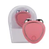 Pink portable facial massager with metallic rolling balls and a USB charging port, displayed in a clear plastic case.