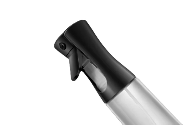 Close-up of the spray nozzle on a black oil sprayer against a white background.