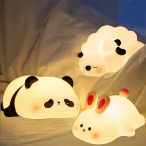 Assorted animal-shaped LED nightlights on bed.